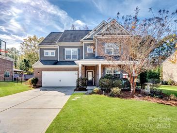 Two story home with gray siding, brick accents, and a landscaped yard at 2741 Smethwick Ln, Gastonia, NC 28056