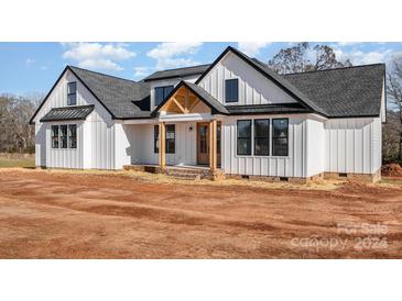 Modern farmhouse exterior, white siding, and a welcoming porch at 4227 Brandy Creek Ct, Clover, SC 29710