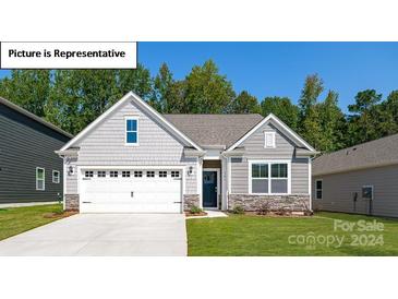 Gray exterior house with white garage door and landscaped lawn at 122 Meadow View Dr, Statesville, NC 28677