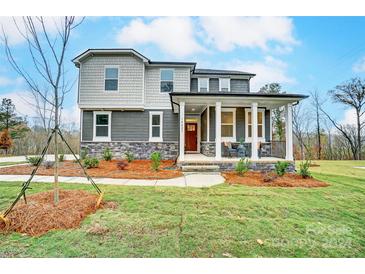 Two-story home with gray siding, stone accents, and a covered front porch at 14421 Autumncrest Rd # 3, Huntersville, NC 28078