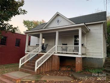 Charming white house with front porch and rocking chairs at 2005 Cleveland Ave, Charlotte, NC 28203