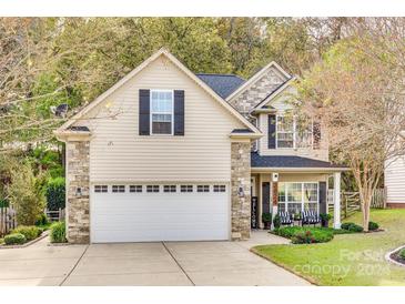 Two-story house with stone accents, a large garage, and a welcoming front porch at 2824 Huckleberry Hill Dr, Fort Mill, SC 29715