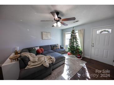 Bright living room with sectional sofa, Christmas tree, and hardwood floors at 1106 Chandler Dr, Rock Hill, SC 29732