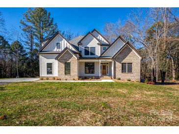 Two-story home with brick and siding, featuring a welcoming front porch at 314 Henry Chapel Rd, Belmont, NC 28012