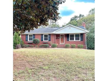 Brick ranch home with a spacious lawn and mature trees at 1532 Starbrook Dr, Charlotte, NC 28210