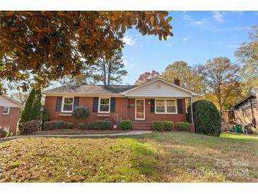 Brick ranch home with a landscaped yard and inviting front porch at 1532 Starbrook Dr, Charlotte, NC 28210