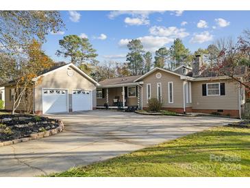 Ranch home with attached two-car garage and a long driveway at 400 Neighbors Dr, Midland, NC 28107