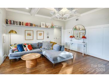 Bright living room with sectional sofa, wood floors, and stylish decor at 843 Ideal Way # 11, Charlotte, NC 28203