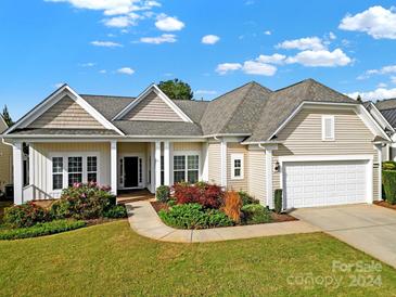 Beige house with white columns, landscaping, and a two-car garage at 4022 Blackburn Ct, Fort Mill, SC 29707