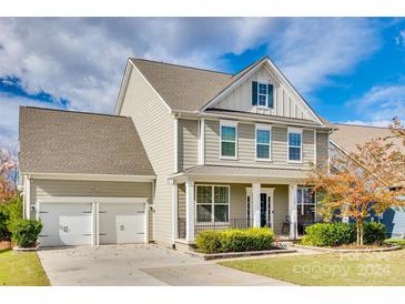 Two-story house with beige siding, two-car garage, and a front porch at 770 Kathy Dianne Dr, Fort Mill, SC 29707