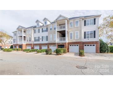 Three-story building with multiple units, garages, and landscaping at 6227 Creek Park Dr, Charlotte, NC 28262