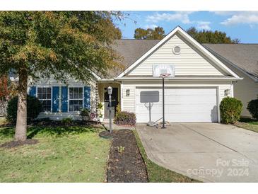 Inviting exterior featuring a two-car garage and well-manicured lawn at 11638 Village Pond Dr, Charlotte, NC 28278