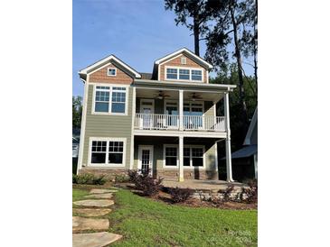 Two-story craftsman style home with large front porch and stone accents at 698 Lake Head Rd, Norwood, NC 28128