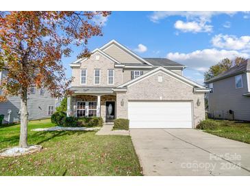 Two-story brick home with attached garage and landscaped lawn at 12816 Cumberland Cove Dr, Charlotte, NC 28273