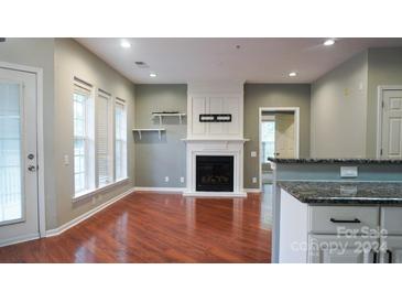 Spacious living room with hardwood floors and fireplace at 3248 Margellina Dr, Charlotte, NC 28210