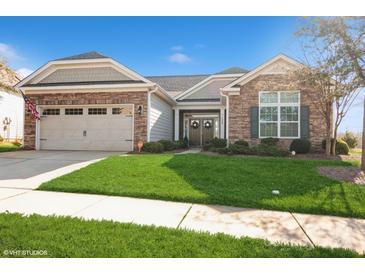 Brick and stone one-story house with a two-car garage and manicured lawn at 5020 Star Hill Ln, Charlotte, NC 28214