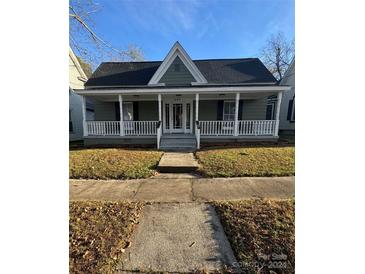 Charming house with front porch and a well-maintained lawn at 409 S Rowan Ave, Spencer, NC 28159