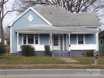 Charming light blue house with white trim and porch at 1720 S Main St, Salisbury, NC 28144