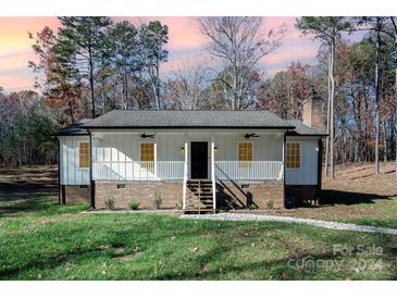 Charming white farmhouse exterior with a welcoming front porch at 359 Will Hall Rd, Kings Mountain, NC 28086