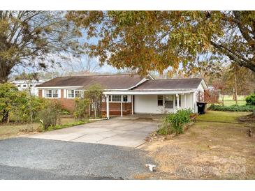 Brick ranch house with carport and mature trees at 3524 Wolfe Rd, Monroe, NC 28110