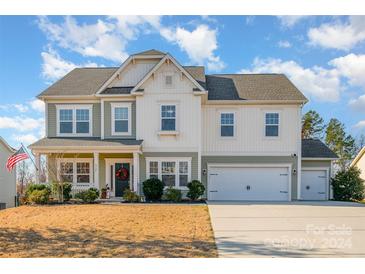 Two-story house with a two-car garage, front porch and landscaped yard at 6721 Lennox St, Indian Land, SC 29707