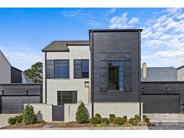 Modern two-story home with dark accents and landscaped yard at 9025 Tynecastle Commons Ct # 2, Charlotte, NC 28226