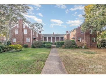 Brick building with a walkway, landscaping, and classic architecture at 2240 Roswell Ave # 4, Charlotte, NC 28207