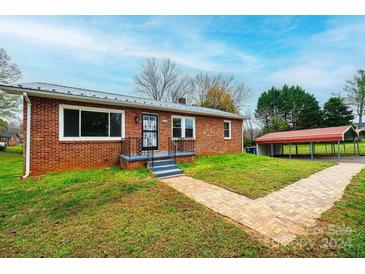 Brick ranch house with a walkway, landscaping, and a carport at 2752 21St Ne St, Hickory, NC 28601