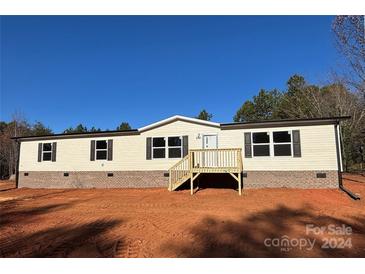 Newly constructed single-wide mobile home with brick skirting and a deck at 3365 34Th Avenue Ne Ct, Hickory, NC 28601