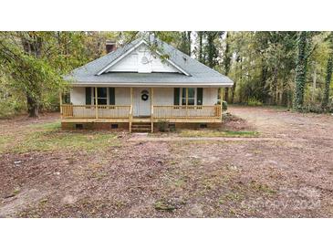 Charming white house with a porch, surrounded by trees at 7057 Citation St, York, SC 29745