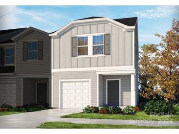 Two-story townhome with gray siding, white accents, and a two-car garage at 2003 Old Rivers Rd, Concord, NC 28027