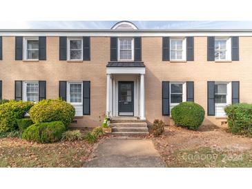 Brick building with dark shutters, entryway, and landscaping at 405 Wakefield Dr # B, Charlotte, NC 28209