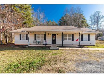 Ranch style home with covered porch, landscaping, and large backyard at 1776 Molly Cir, York, SC 29745