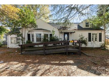 White house with wood ramp and mature trees at 407 King St, Monroe, NC 28110