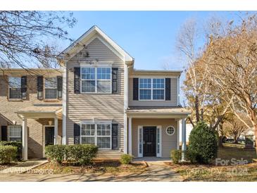 Two-story townhome with neutral siding and a charming front porch at 4337 Glenlea Commons Dr, Charlotte, NC 28216