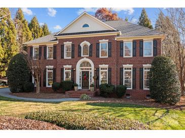 Brick two-story home with a landscaped yard and shutters at 9442 Titus Ln, Huntersville, NC 28078