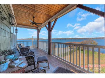 Relaxing lakefront view from a spacious deck with comfortable seating at 49412 Wood Land Dr, Norwood, NC 28128