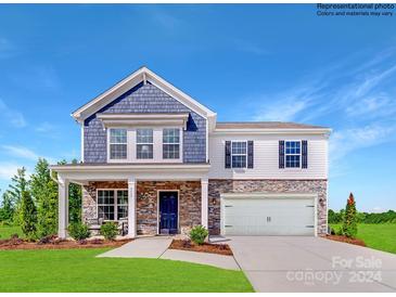 Two-story home with blue and white siding, stone accents, and a two-car garage at 1431 Pine Heart Dr, Edgemoor, SC 29712