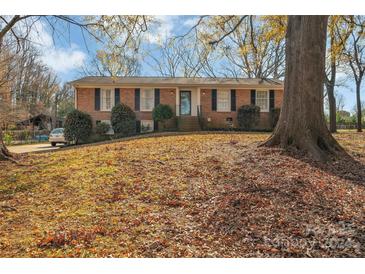 Brick ranch home with mature trees and landscaping at 7914 Rainbow Dr, Charlotte, NC 28227