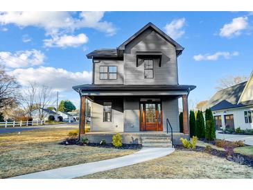 Gray two-story house with a front porch and landscaped yard at 901 Edgemont Ave, Belmont, NC 28012