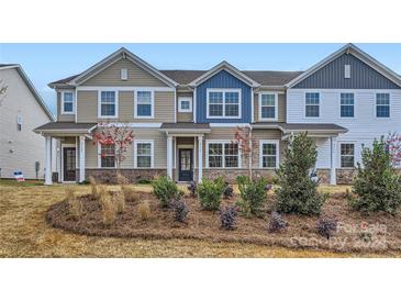 Two-story townhome with neutral siding and landscaping at 9732 Inkberry Dr, Gastonia, NC 28056