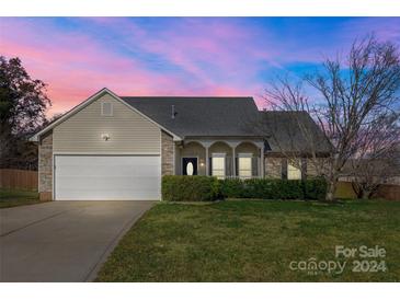 Nice two-story house with a white garage door and landscaped lawn at 2934 Cripple Creek Ct, Monroe, NC 28110