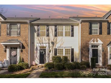 Brick front end unit townhome with landscaping and walkway at 6428 Hasley Woods Dr, Huntersville, NC 28078