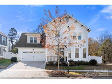 Two-story white house with a gray roof, two-car garage, and landscaping at 12502 Stonebriar Ridge Dr, Davidson, NC 28036