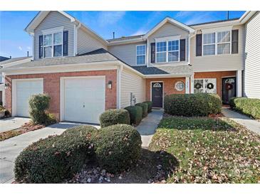 Attractive exterior of a two-story townhome with a brick facade and landscaping at 3507 Summerfield Ridge Ln, Matthews, NC 28105