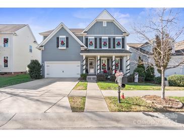 Two-story home with gray siding, white trim, and a welcoming front porch at 518 Lakeview Dr, Mcadenville, NC 28101