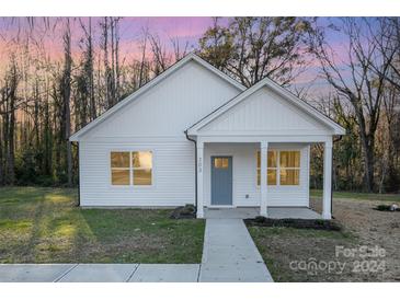 Charming white house with gray door and walkway at 203 Williams St, York, SC 29745