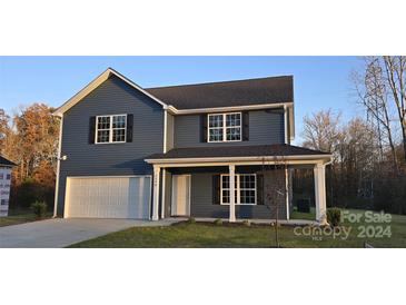 Two-story house with gray siding, white trim, and a covered porch at 2308 Grayson Pkwy, Monroe, NC 28110