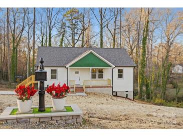 Newly constructed home with white siding, green accents, and a landscaped yard at 120 Sills Dr # 45, Salisbury, NC 28146