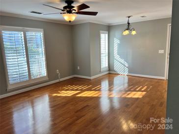 Bright living room with hardwood floors and plantation shutters at 2518 Cranbrook Ln, Charlotte, NC 28207